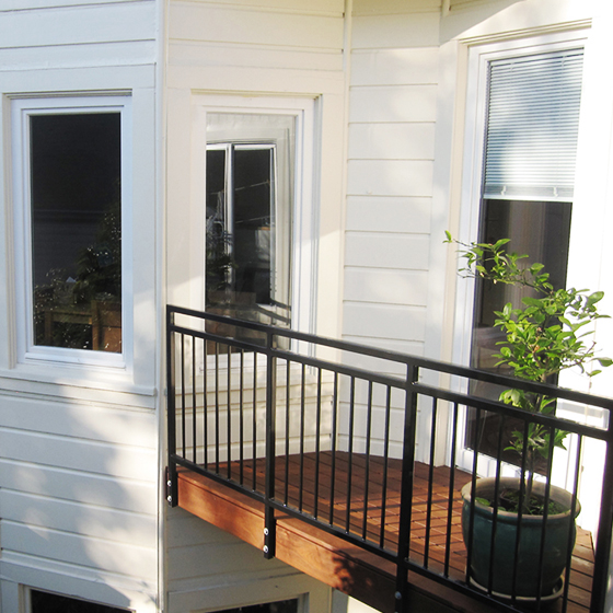 Added balcony between bayview window and leanto. Ipe wood, custom metal railing. 