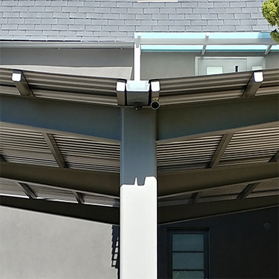 Carport with charger station and replaceable metal roof panels for future PV cell installation