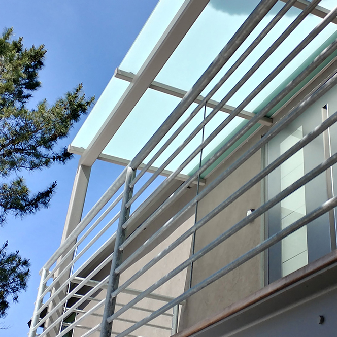 Entry deck with sandblasted glass canopy. Pirnar entry door.